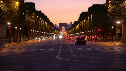 The Arc de Triomphe de l'Etoile in Paris during twilight sky