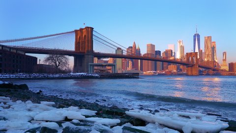 Panoramic view of Brooklyn bridge and Manhattan at sunrise, New York City.