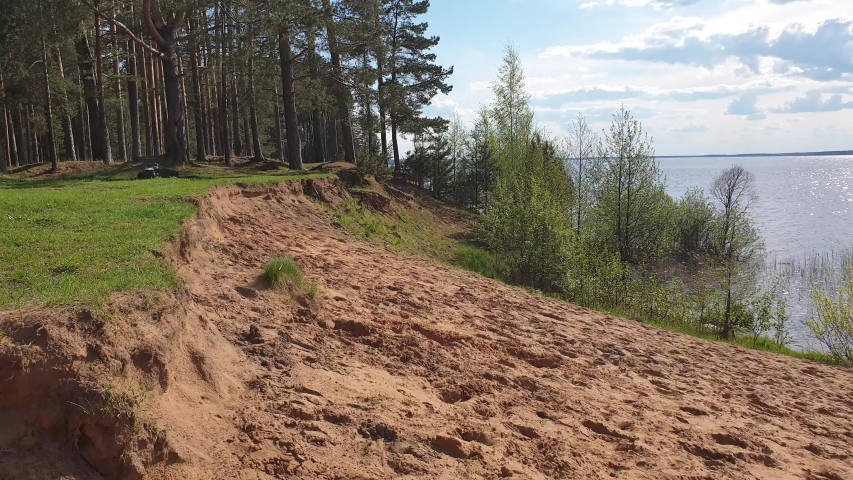 Somersault off a cliff. Man doing flips on the sand slow motion