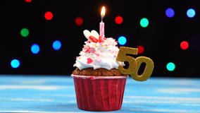 Delicious birthday cupcake with burning candle and number 50 on multicolored blurred lights background. - Powered by Shutterstock - Get 15% off with code: PIKWIZARD15