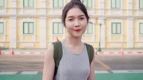 Asian blogger woman travel in Bangkok, Thailand, backpacker female using mobile phone make vlog and live in social media while spending sweet time in holiday trip. Women travel in city concept.