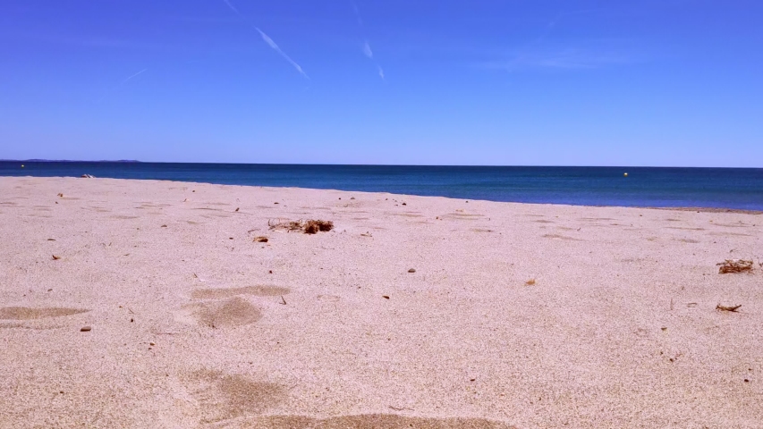 Vacation holidays. Man feet closeup relxing on beach on sunbed enjoying sun on sunny summer day. Legs with jeans