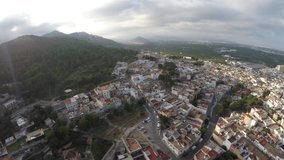 Drone shot of mountain/hill and many houses in Spain