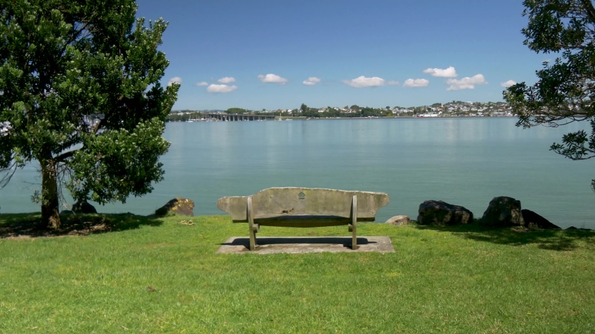 A funny timelapse of a person entering the frame again and again sitting on a bench in a park and leaving as time flies by.