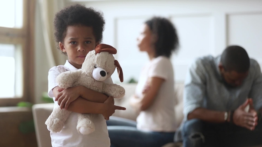 Sad small child boy holding toy looking at camera as divorce custody impact on children concept, upset little kid son feel frustrated about parents conflicts fights suffer from psychological trauma | Shutterstock HD Video #1029713942