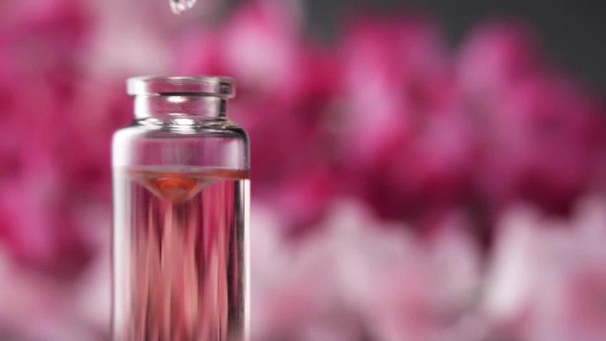Blend of essential oils. Making some aroma liquids, perfume. Drops falling from pippet to little glass bottle. Slowmotion. | Shutterstock HD Video #1029715637
