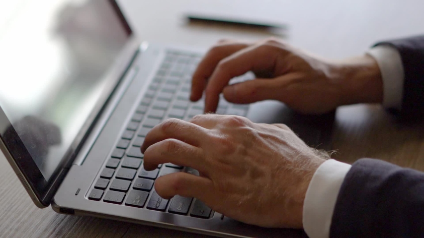 Closed-up View of Businessman Working at the Laptop. Male Hands in Business Suit Tapping the Keybord. Man Types on Keybord. | Shutterstock HD Video #1029720209