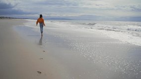 Running happy girl by the ocean in California