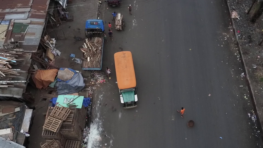 Aerial Shot Of A Jeepney Travelling On A Busy, Dirty Road Of Manila Philippines