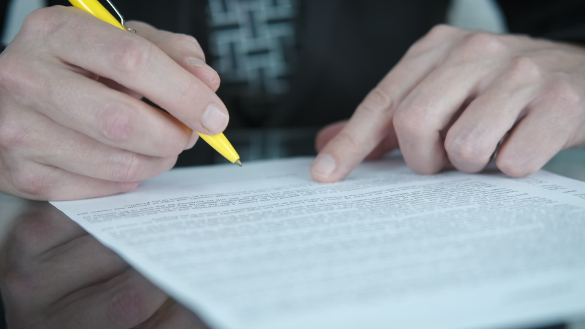Signing a contract. A man signs a contract. Blur.