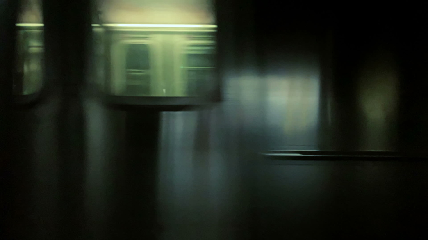 NEW YORK - MAY 12, 2019: express subway passing other moving train on tracks interior pov New York City NYC.