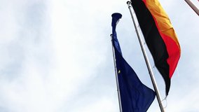 A video of the European, German, Spanish, French and British Flag waving in the wind. The camera is moving backward and reveals every flag one by one.