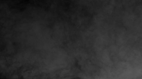 Uneven Smoke Curtain. Gray smoke on a black background slowly dissipates and disappears from the screen