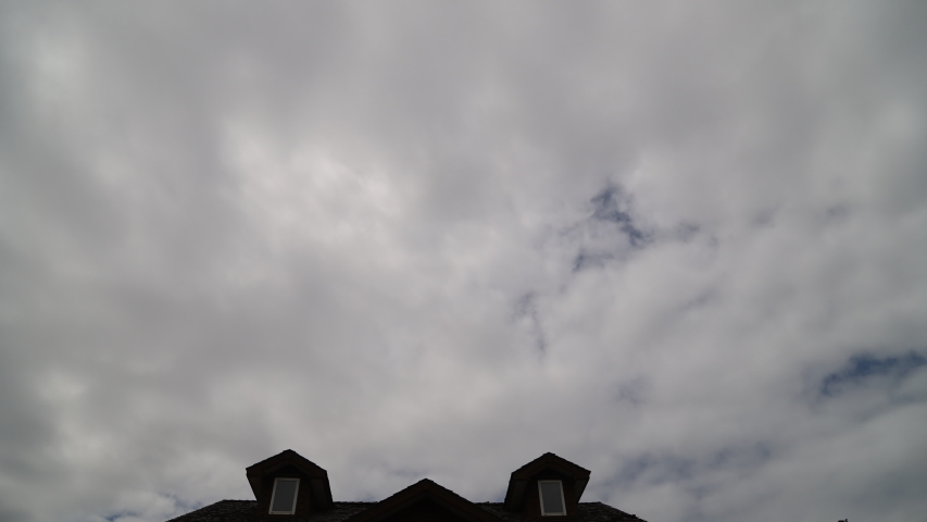capricious clouds passing above the roof