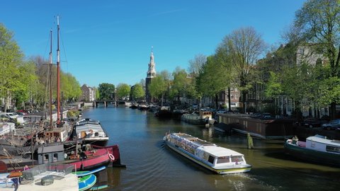 Aerial view of cityscape of Amsterdam, capital city of Netherlands, historic centre, famous water canal system with boats and ships, traditional houses - landscape panorama of Europe from above