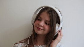 Teen girl is singing and listen to music on headphones