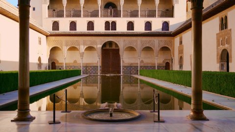 GRANADA, SPAIN - MAY 12, 2019: The Nasrid Palaces Courtyard of the Myrtles in the Alhambra fortress in Granada, Spain