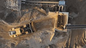 Overhead aerial view loading bulldozer in open air quarry.