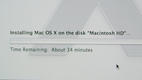 CALIFORNIA, UNITED STATES - CIRCA 2014: Apple Computers new desktop computer iMac with progress bar installing Mac Os X on the disk Macintosh HD