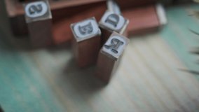 Close up footage of alphabet letters rubber stamps.  Selective focus.