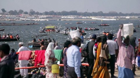Allahabad, Uttar Pradesh / India - February 23, 2019: People are roaming around near holy river "The Ganges"  during the event Ardh Kumbh Mela.