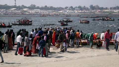 Allahabad, Uttar Pradesh / India - February 23, 2019: People are roaming around near holy river "The Ganges"  during the event Ardh Kumbh Mela.