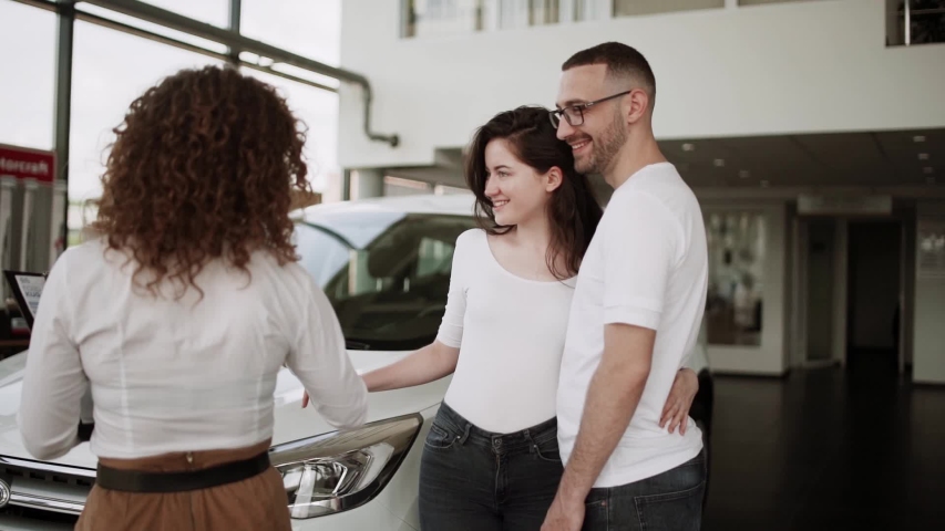family buys cars in a car dealership