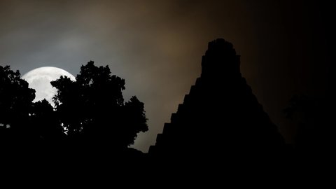 Tikal by Night with Full Moon: Ruin of Ancient Mayan City with Pyramid in one of the largest archaeological sites of Maya, Rainforest of Guatemala