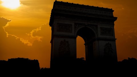 The Arc de Triomphe de l'Etoile or Triumphal Arch of the Star: Time Lapse at Sunset, one of the most famous monuments in Paris, France