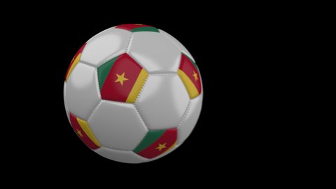 Soccer ball with flag Cameroon flies past camera, slow motion blur, 4k footage with alpha channel