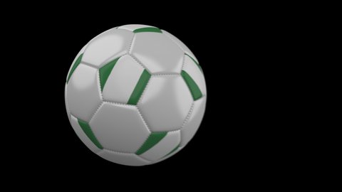 Soccer ball with flag Nigeria flies past camera, slow motion blur, 4k footage with alpha channel