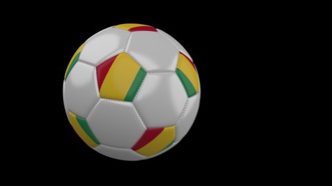 Soccer ball with flag Guinea flies past camera, slow motion blur, 4k footage with alpha channel
