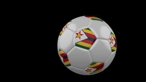 Soccer ball with flag Zimbabwe flies past camera, slow motion blur, 4k footage with alpha channel