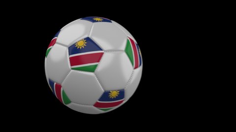 Soccer ball with flag Namibia flies past camera, slow motion blur, 4k footage with alpha channel
