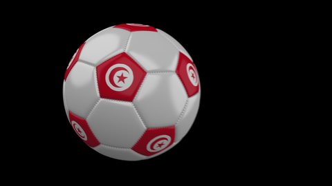 Soccer ball with flag Tunisia flies past camera, slow motion blur, 4k footage with alpha channel
