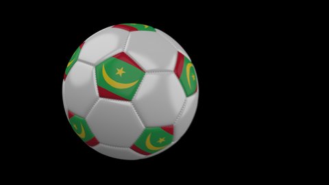 Soccer ball with flag Mauritania flies past camera, slow motion blur, 4k footage with alpha channel