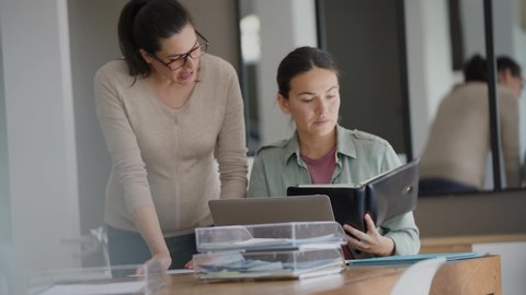 Women working in office on laptop computer