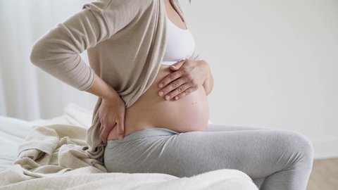 Pregnant woman having contractions at home