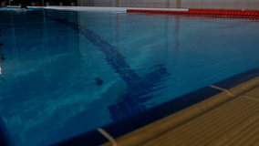 Young woman professional swimmer doing freestyle and flip turn in swimming pool, Full HD shot - Powered by Shutterstock - Get 15% off with code: PIKWIZARD15