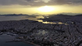 Aerial drone bird's eye view video of famous port of Piraeus one of the largest in Europe at sunset with beautiful golden colours, Attica, Greece