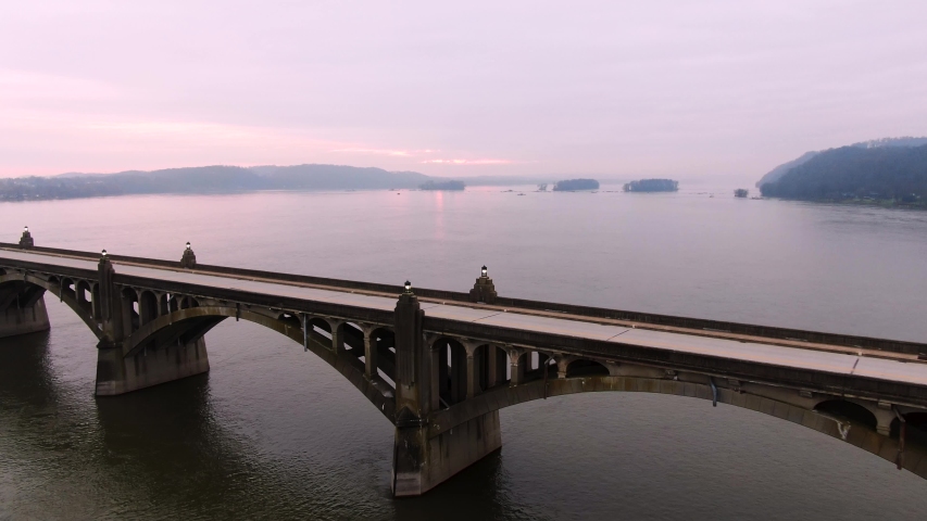 Aerial flyover an empty Veterans Memorial Bridge into the pink and purple sunrise over the islands near Wrightsville Pennsylvania, in the Susquehanna River.Concept: escape, dawn, ?optimism