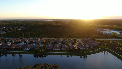 Flying out over lakeside homes and farms during a beautiful Florida Spring sunset