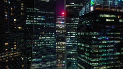 night time illumination singapore downtown buildings front aerial panorama 4k