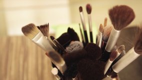 Make up kit of brushes by the table ready to be used | SLOW MOTION