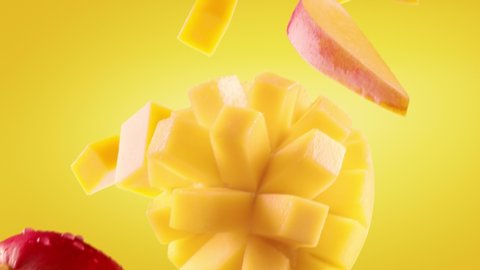 Mango with Slices Falling on Yellow Background