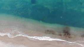 Beach aerial - a high view of waves crashing from a drone