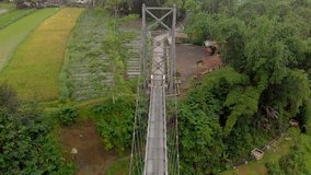 Small steel suspension bridge aerial footage bird view from center above