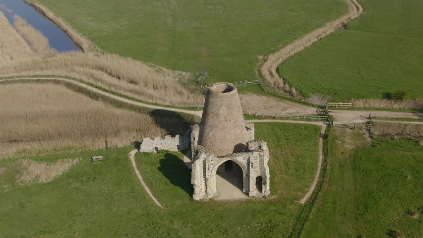 AERIAL: Circling around a ruined Windmill built inside of the ruins of St Benet