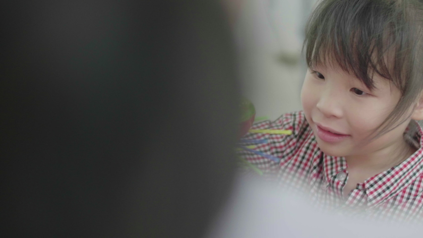Cute asian little girl playing with mother at home. Excited girl playing with toys.