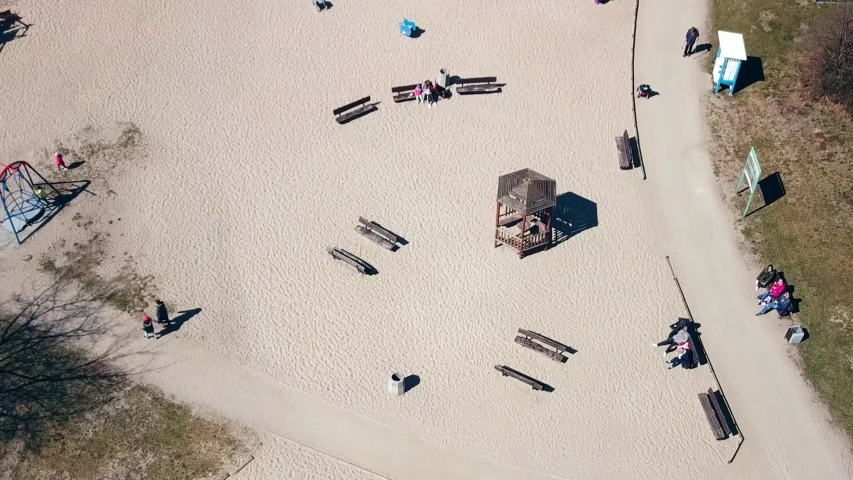 Playground aerial shot. Children playing. Public playground in Ronald Reagan Park, Gdansk, Poland. Simple flyby shot. Spring 2019